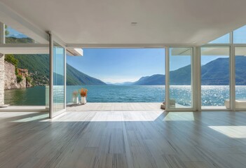 Spacious interior with panoramic lake views, showcasing expansive glass doors and a serene atmosphere.