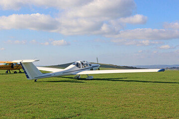Light airplane standing on a grass runway	