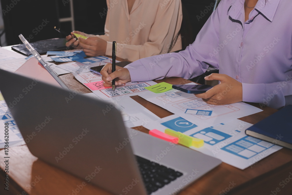 Wall mural close up ux developer and ui designer brainstorming about mobile app interface wireframe design on t