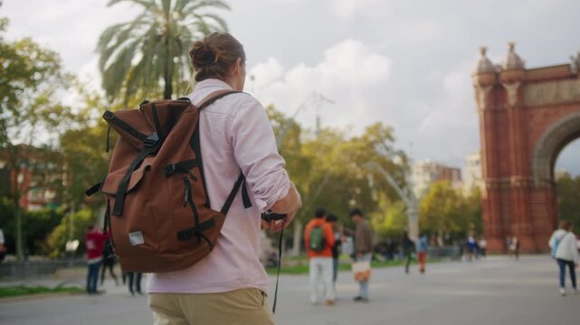 Happy tourist man in Barcelona, Spain. Vacation exploring interesting places to travel, student vacation, young man portrait walking in gothic square, old european city. 