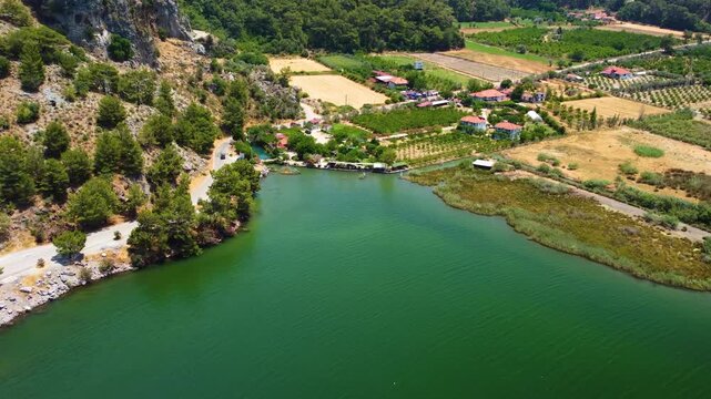 aerial footage captures the breathtaking beauty of Iztuzu Beach, also known as Turtle Beach, and the lush Dalyan River delta in Turkey. This protected natural area is famous for its golden sands, turq