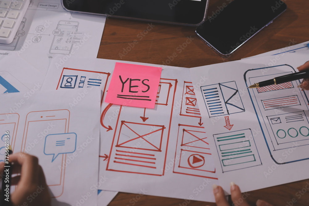Wall mural close up ux developer and ui designer brainstorming about mobile app interface wireframe design on t