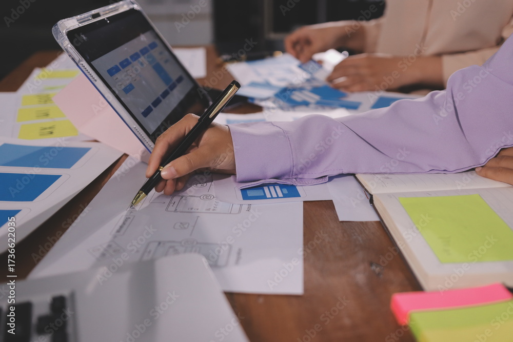 Wall mural close up ux developer and ui designer brainstorming about mobile app interface wireframe design on t
