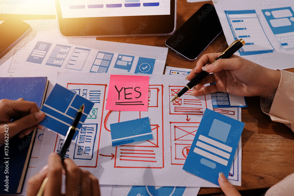 Wall mural close up ux developer and ui designer brainstorming about mobile app interface wireframe design on t