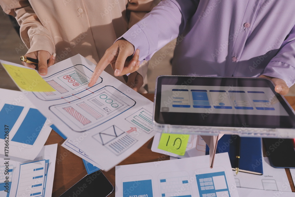 Wall mural close up ux developer and ui designer brainstorming about mobile app interface wireframe design on t