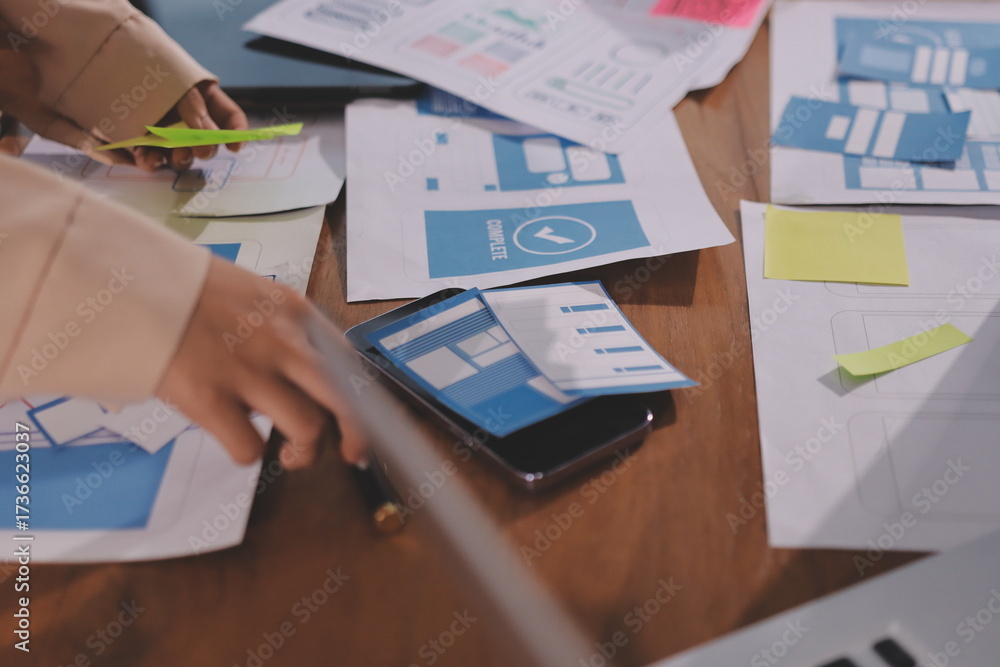 Wall mural close up ux developer and ui designer brainstorming about mobile app interface wireframe design on t