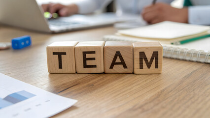 Wooden Blocks Spelling TEAM Collaboration, Business Strategy, and Workplace Success Concept Close-up of TEAM Word Blocks on an Office Desk with Blurry Background of Professionals Working