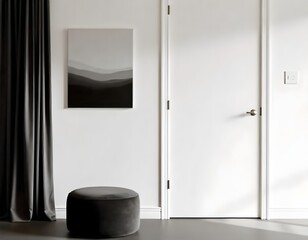 White door with white handle, a black and white painting on the wall, a black curtain and a black pouf in a gray room.
