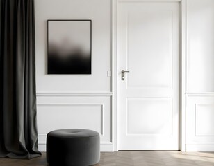 White door with white handle, a black and white painting on the wall, a black curtain and a black pouf in a gray room.