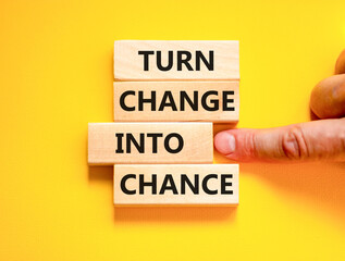 Turn change into chance symbol. Concept words phrase Turn change into chance on beautiful wooden blocks. Beautiful yellow paper background. Business Turn change into chance concept. Copy space.