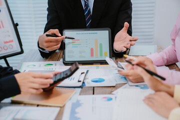 Close up of hands and stationery of Business people counting on calculator sitting at the table