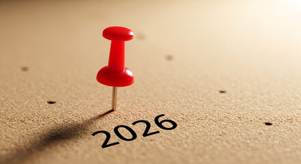Red pushpin marking the year 2026 on a cork bulletin board. Concept for future planning, setting deadlines, and new year goals.