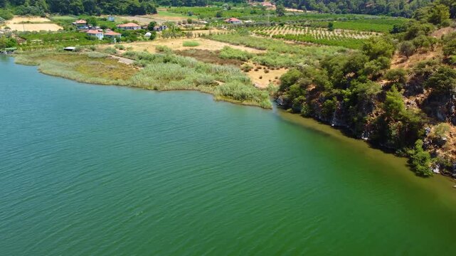 An aerial perspective captures the tranquil turquoise waters of the Dalyan River delta merging with the Mediterranean Sea, showcasing the natural beauty of Iztuzu Beach in Dalyan, Turkey.