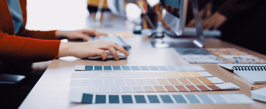 A dynamic creative workspace featuring color palettes and design tools, illustrating the collaborative process in interior design and artistic projects. SACTR