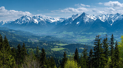 Obraz premium Panoramic view of majestic snowy peaks rising above lush green meadows, showcasing the breathtaking beauty of mountainous landscapes and nature's tranquility