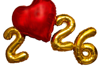 A golden sign with the year 2026 written on it with a heart..