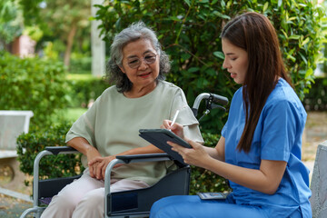 Caring caregiver provides assistance and support to senior in wheelchair, ensuring comfort and well being during their interaction. This moment highlights importance of care