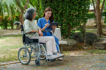 Caregiver provides assistance and support to senior in wheelchair, showcasing importance of care in serene outdoor setting