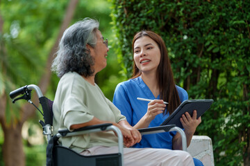 Caring caregiver provides assistance and support to senior in need of care while enjoying pleasant outdoor conversation