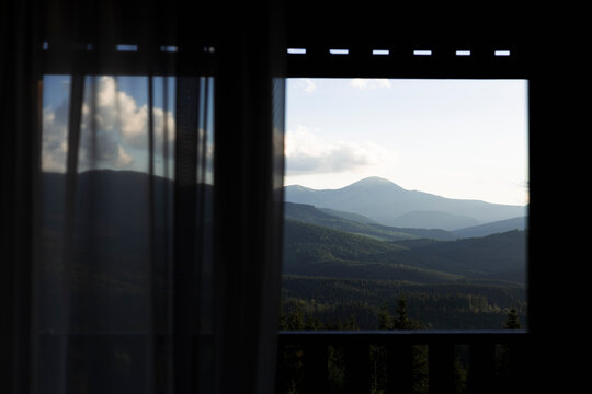 Fototapeta Mountain view through window on summer morning