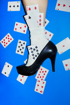 Woman&rsquo;s Leg in High Heel Surrounded by Playing Cards