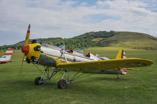 Flugplatzfest, Spitzerberg, Austria, Europe - August 24, 2025: Zlin Z-37 Bumblebee, classic agricultural airplane, parked on grassy countryside airfield with hills in background, symbol of vintage