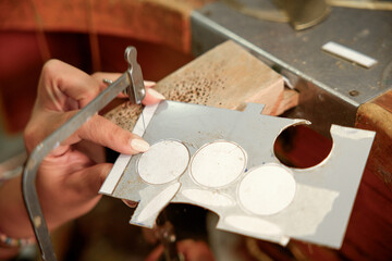 Artisan woman crafting intricate handmade jewelry