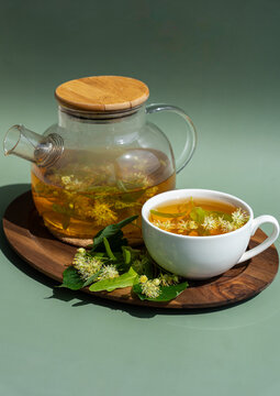 Herbal linden tea with flowers on wooden tray