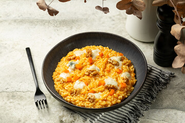 Pumpkin Risotto with Gorgonzola Cheese and walnuts. Italian meal.