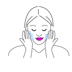 Woman applying facial cleanser in a bright bathroom, practicing skincare routine in the early morning for healthy skin