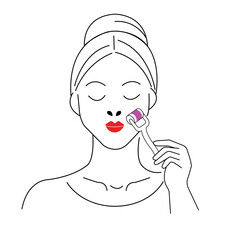 Woman uses a facial roller for skincare in a relaxing indoor setting during self-care routine