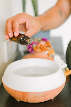 Woman using air purifier with essential oils