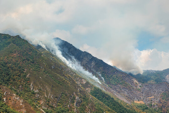 Smoke rising from forest fire in Somiedo Valley
