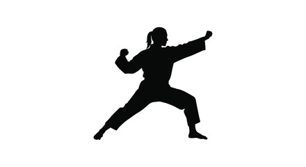 Silhouette of a woman performing a martial arts karate pose with power and agility