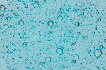 Blue gel texture with bubbles on clear background