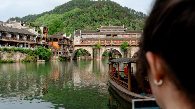 European tourist views Phoenix Hong Bridge in Fenghuang Town