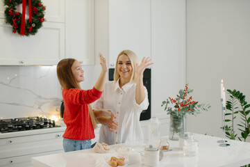 Mother and daughter baking cookies for christmas