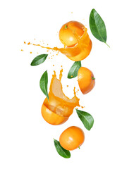 Flying oranges with juice and leaves isolated on a white background