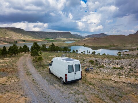 Drone view of camper by Akkoy dam under cloudy sky