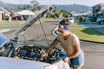 Woman with broken down car on Australian roadside