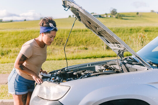 Woman with broken down car in Australia - Powered by Adobe