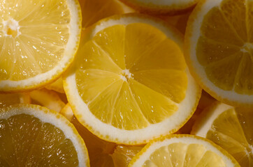 Lemons cut into slices and laid on table as background