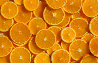Orange rounds spread on surface creating a juicy citrus background.