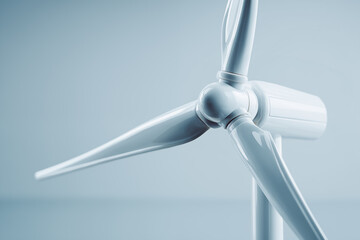 Close-up view of a modern wind turbine against a simple backdrop highlighting renewable energy technology