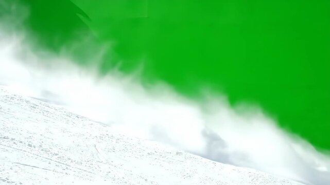Avalanche Simulation on Green Screen - This video depicts a simulated avalanche scene with snow billowing down a slope, set against a vibrant green chroma key background.