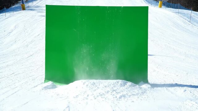Fake Avalanche in Ski Resort with Green Screen - A snow scene with a green screen background used for special effects.