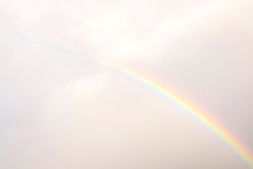 Rainbow stretching across a cloudy sky