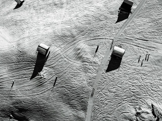 Wooden huts seen from above, in the Alps, on a sunny winter day