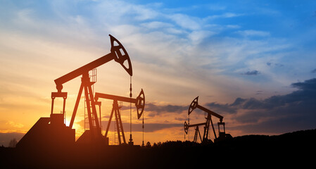 The change in oil prices caused by the war. Oil price cap concept. Oil drilling derricks at desert oilfield. Crude oil production from the ground. Petroleum production.