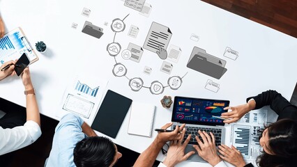 A dynamic workspace showcasing a team collaborating on data analysis and project management using digital tools, visualizations, and modern technology. Raster